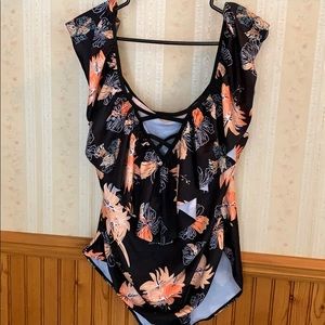Bathing Suit with orange/peach floral print.